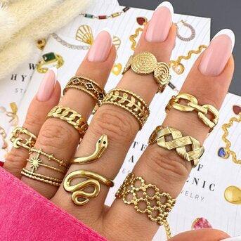 Hand wearing multiple gold waterproof rings in bold and unique designs – 18k gold-plated stainless steel tarnish-free rings for women
