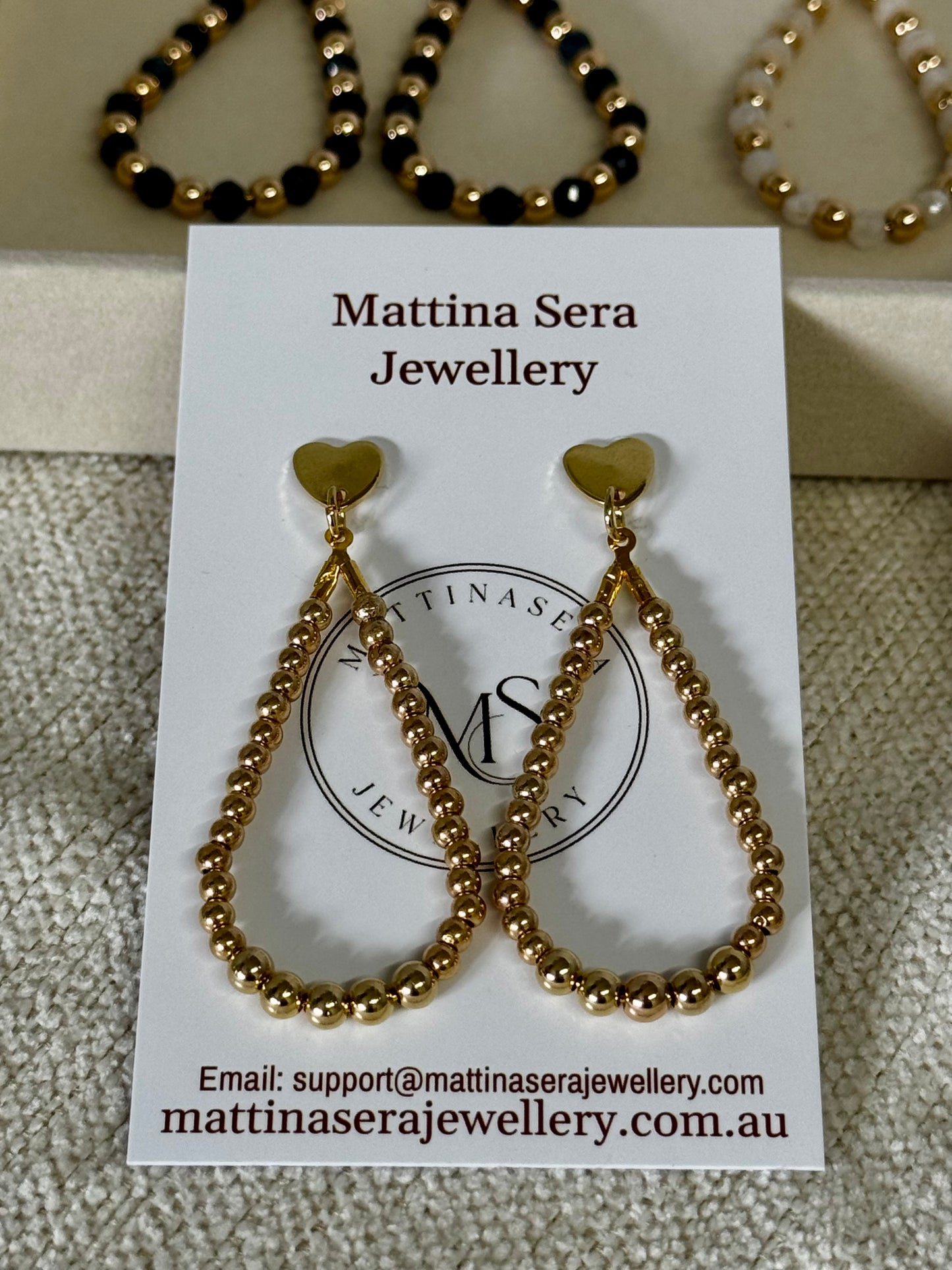 Gold teardrop hoop earrings on earring card Mattina sera jewellery