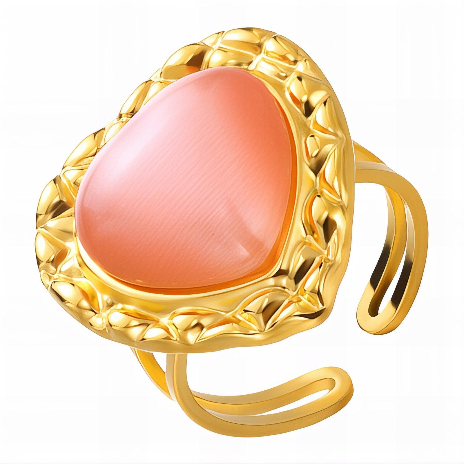 Adjustable heart-shaped statement ring with peach stone and textured 18K gold PVD stainless steel band, modern vintage design