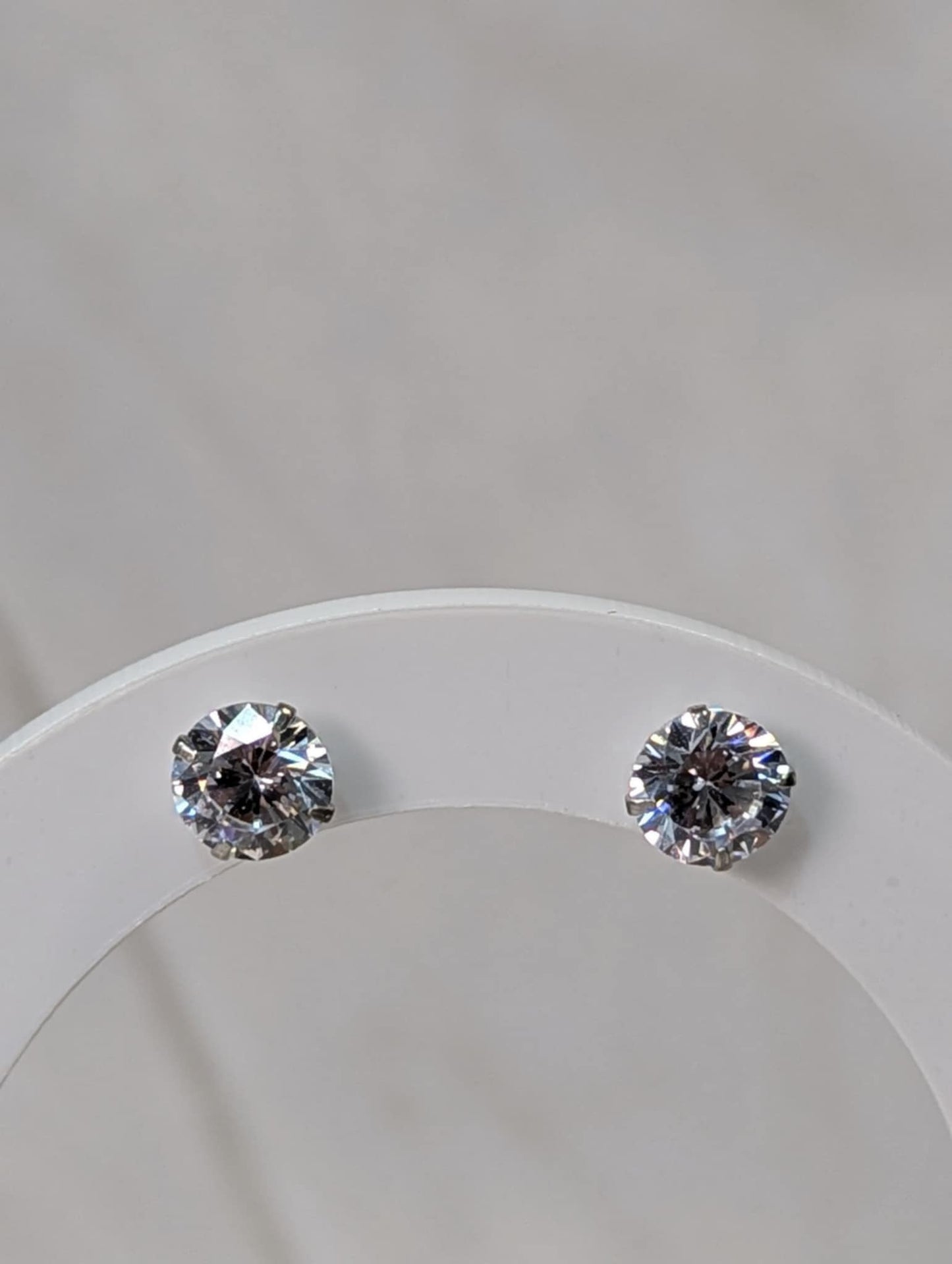 a pair of diamond stud on display