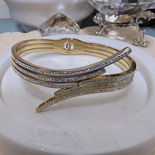 gold bracelet accented with rows of cubic zirconia and rhinestones