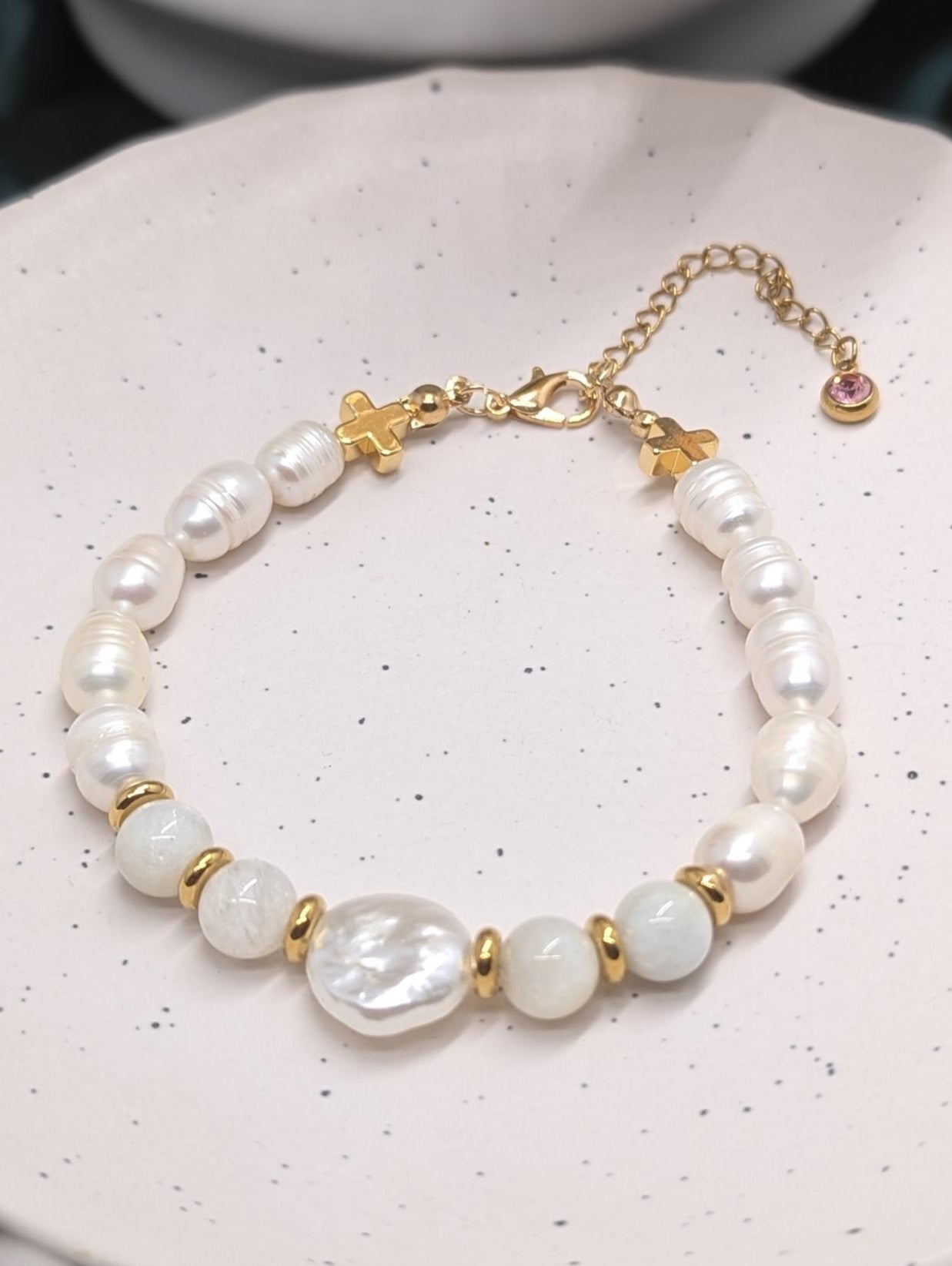 Genuine freshwater pearl bracelet with moonstone beads, gold hematite crosses to accent the bracelet finished with a pink zirconia