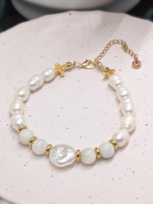 Genuine freshwater pearl bracelet with moonstone beads, gold hematite crosses to accent the bracelet finished with a pink zirconia