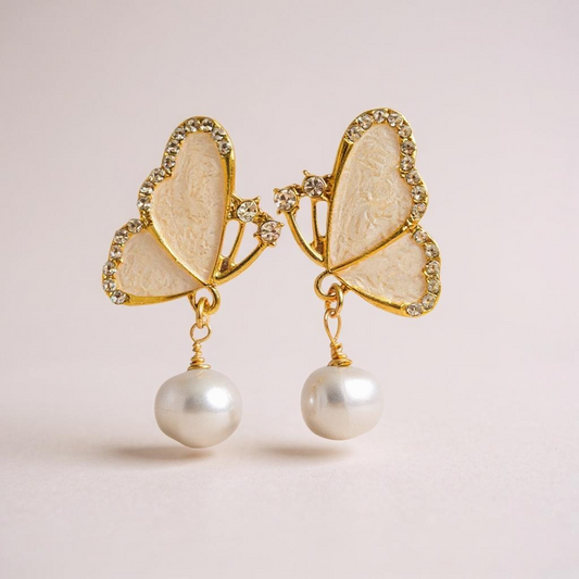 Butterfly wing earrings with pearls hanging from each wing.  