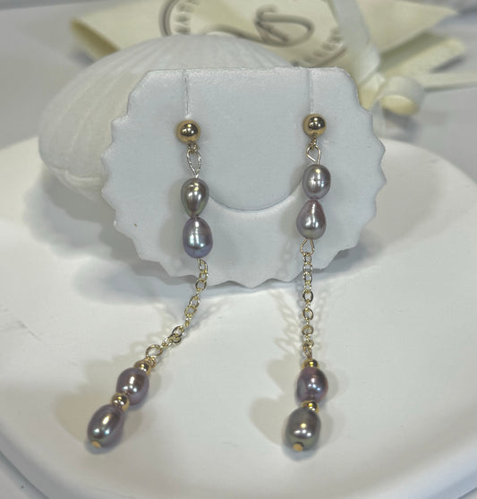 purple pearl gold stud earrings, on a earring card